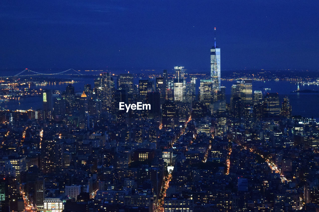 Aerial shot of modern city illuminated at night