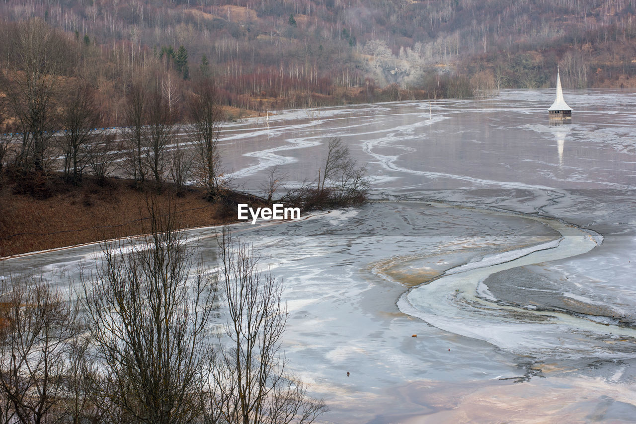 Church submerged by toxic waste waters from  gold mine. decantation lake, geamana, romania