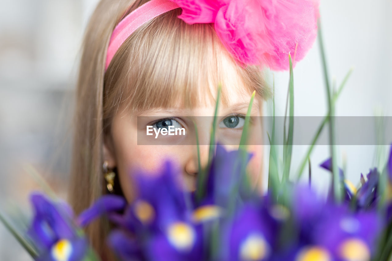 Close-up portrait of girl with flower