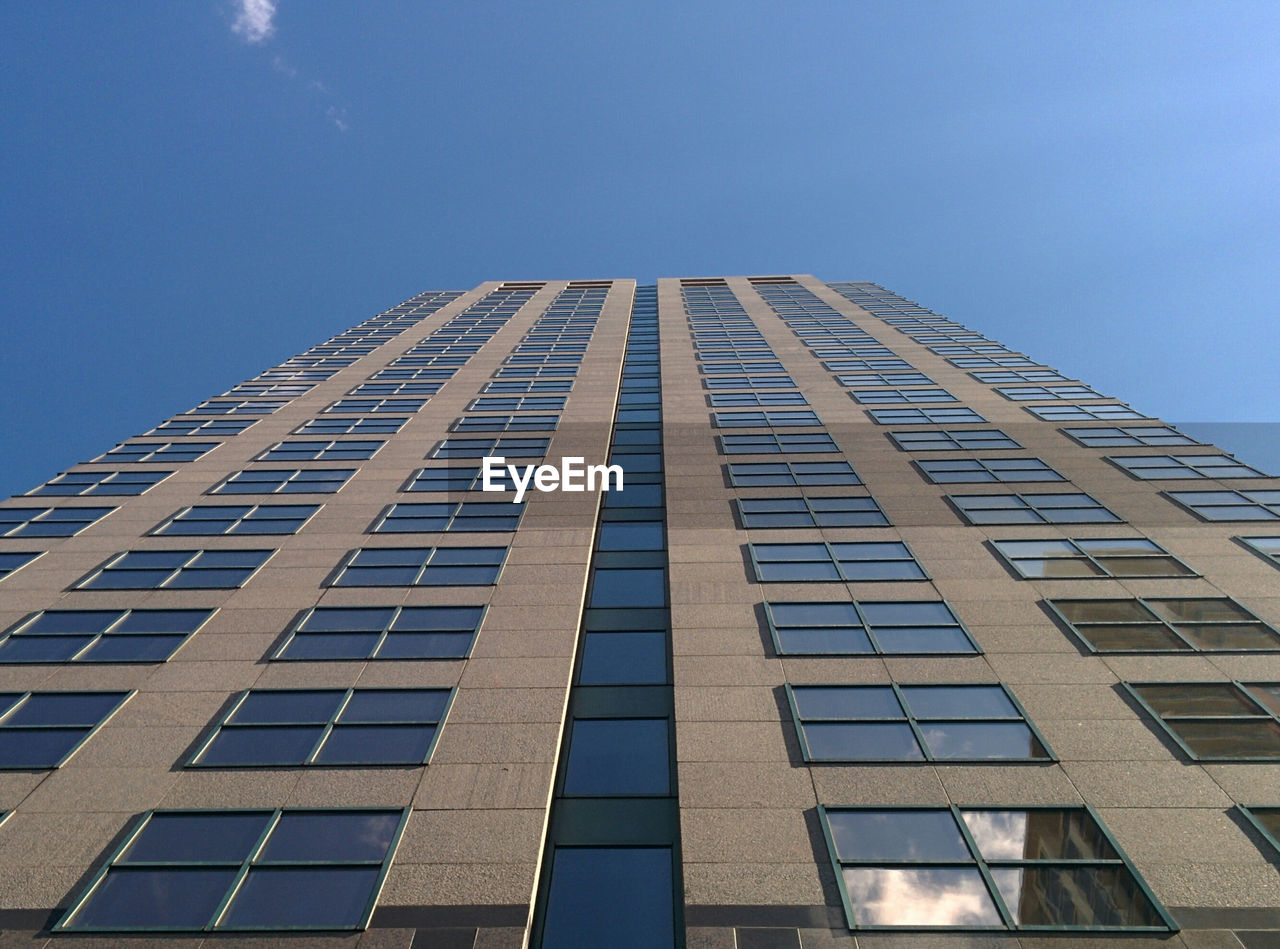 Low angle view of modern building against clear blue sky