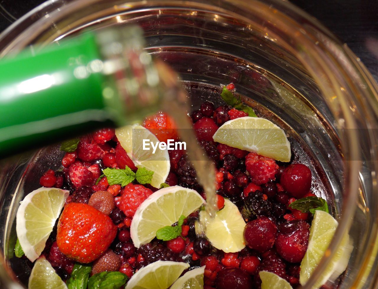 CLOSE-UP OF STRAWBERRIES ON WATER