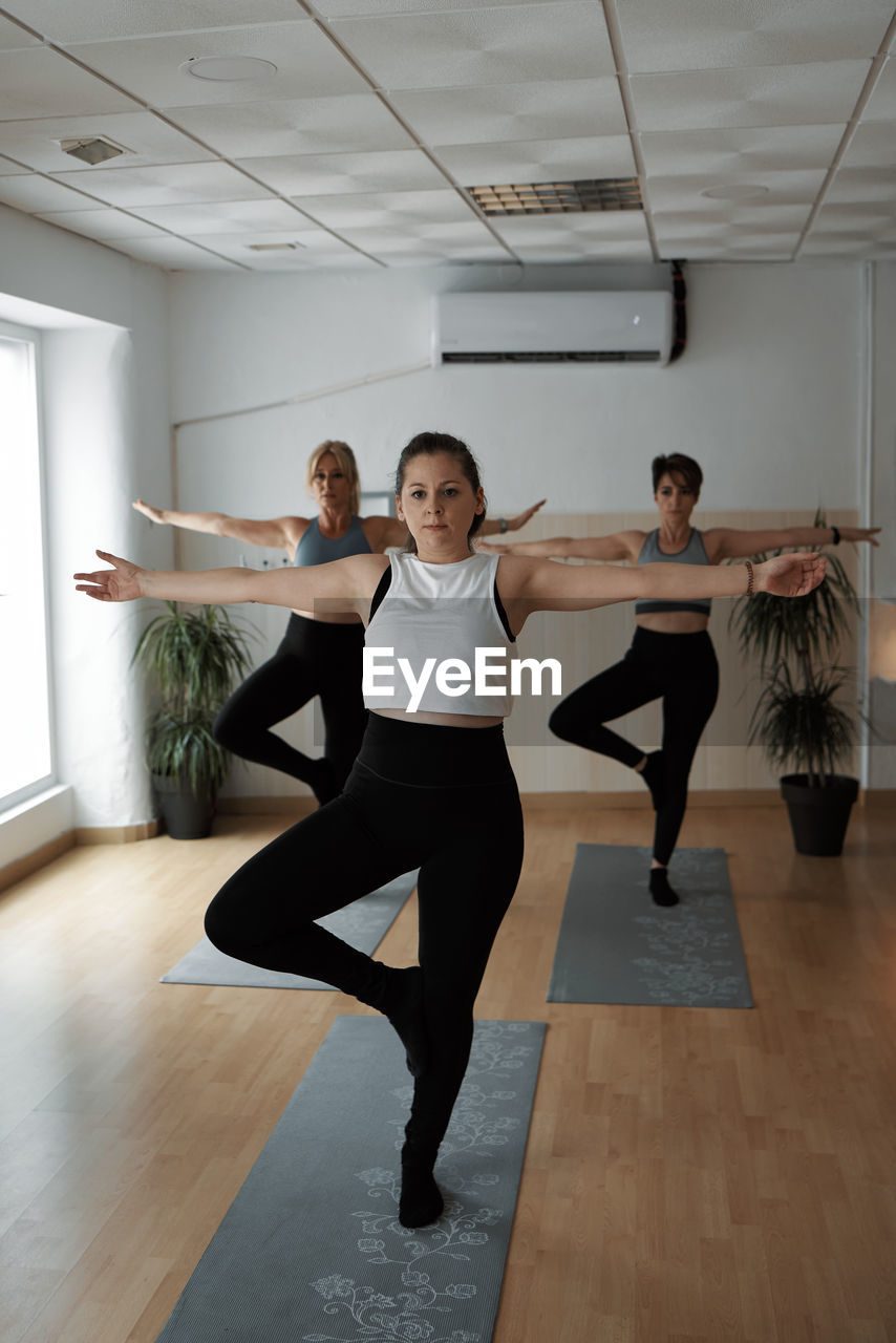 Group of women practicing pilates exercises in class
