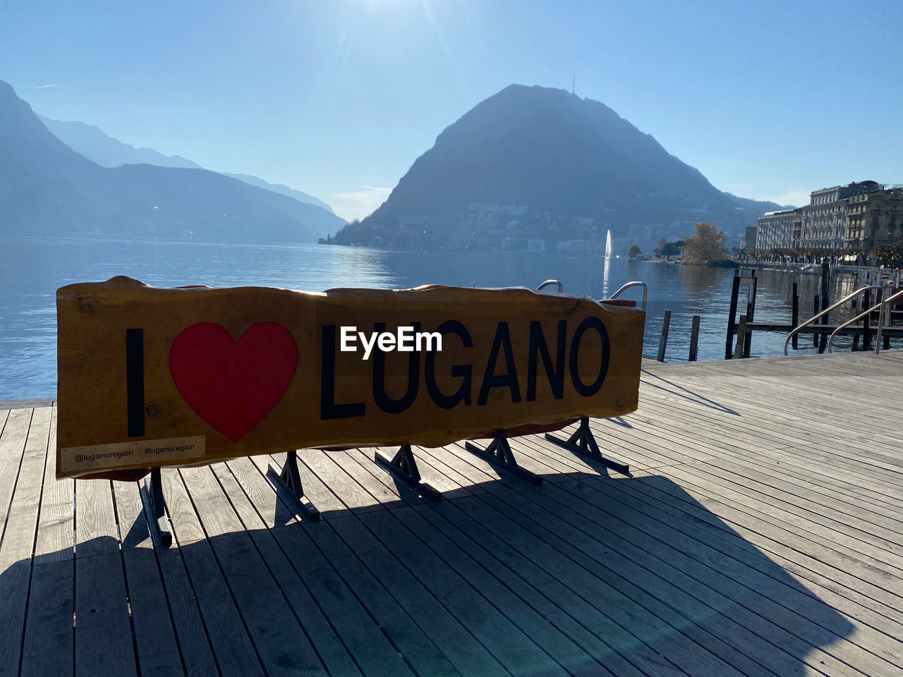 INFORMATION SIGN ON WOOD AGAINST MOUNTAIN