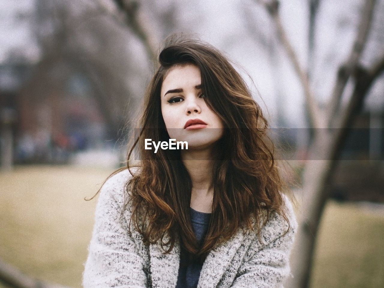 Portrait of beautiful young woman standing at park