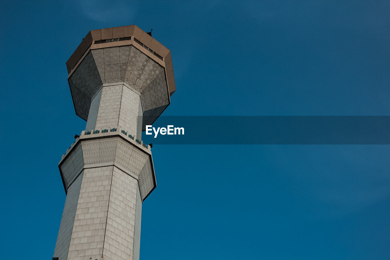 Low angle view of historic building against blue sky