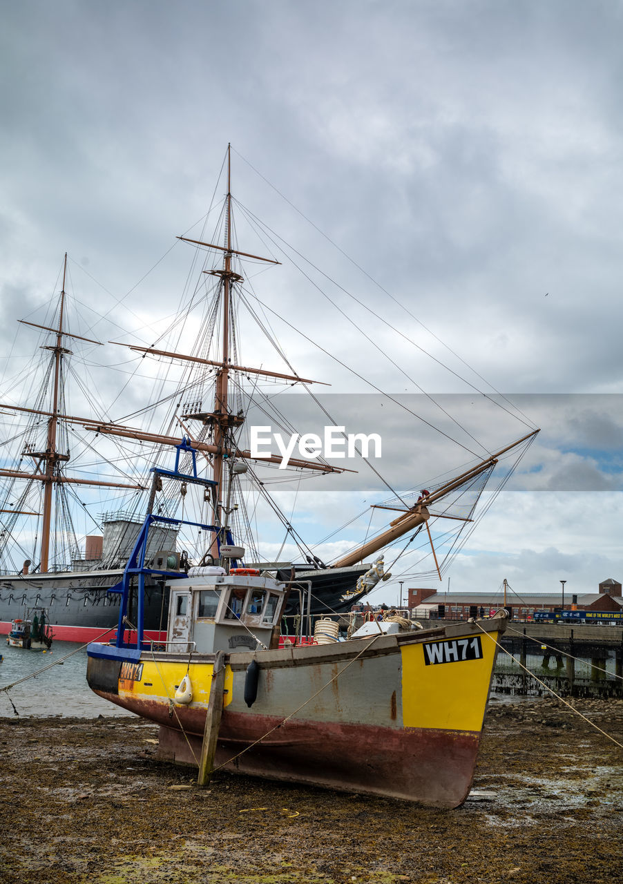 nautical vessel, transportation, mode of transportation, water, sea, sailboat, cloud, vehicle, sky, ship, boat, nature, mast, sailing, pole, sailing ship, harbor, travel, no people, watercraft, beach, moored, outdoors, day, tall ship, history, architecture, coast, travel destinations, the past, galleon, ocean, tourism