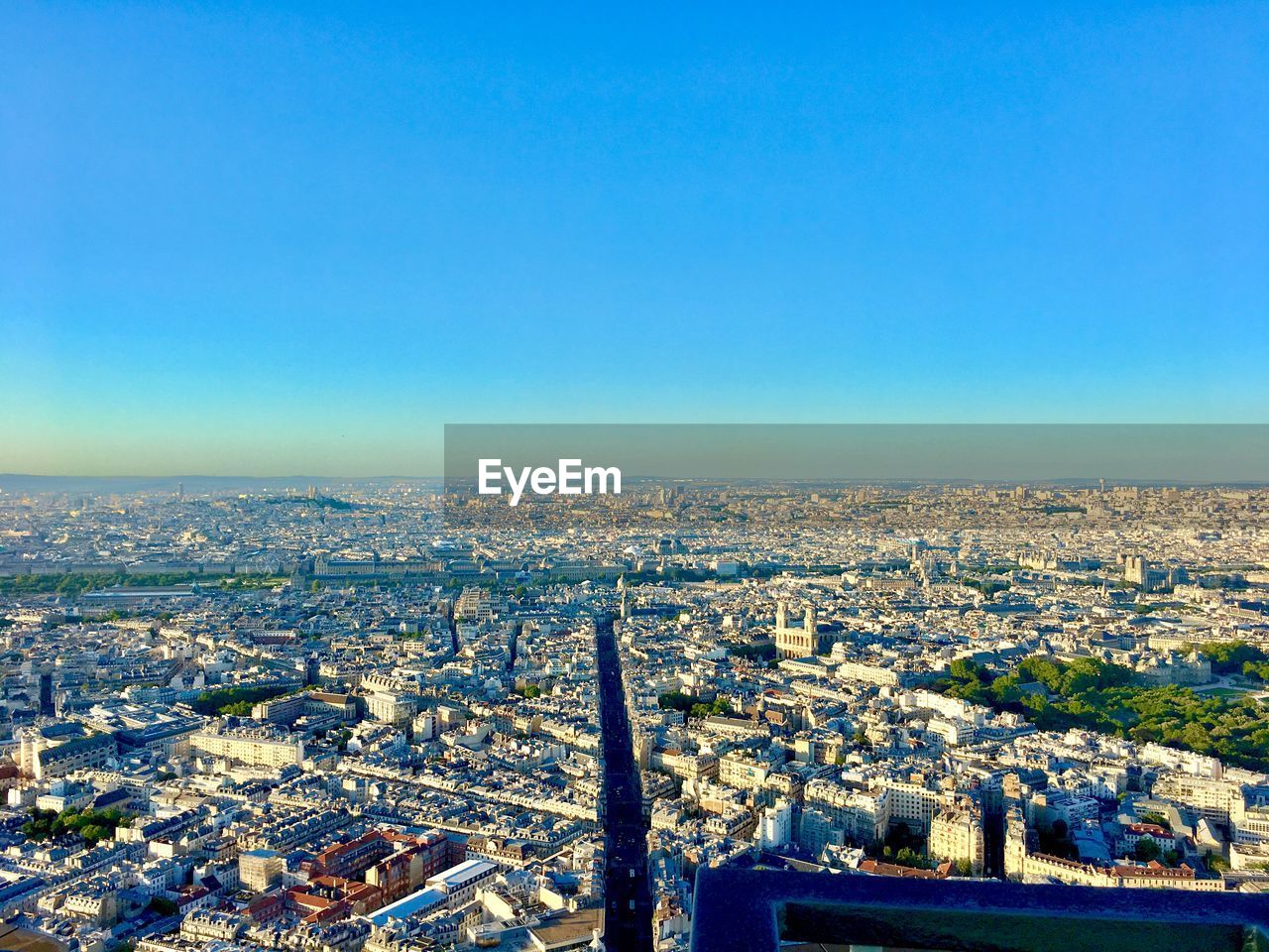 High angle view of buildings against blue sky