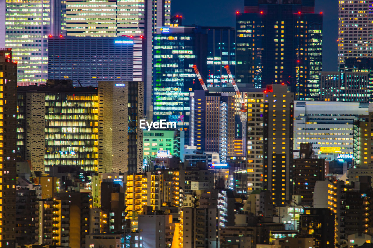 low angle view of illuminated buildings in city at night