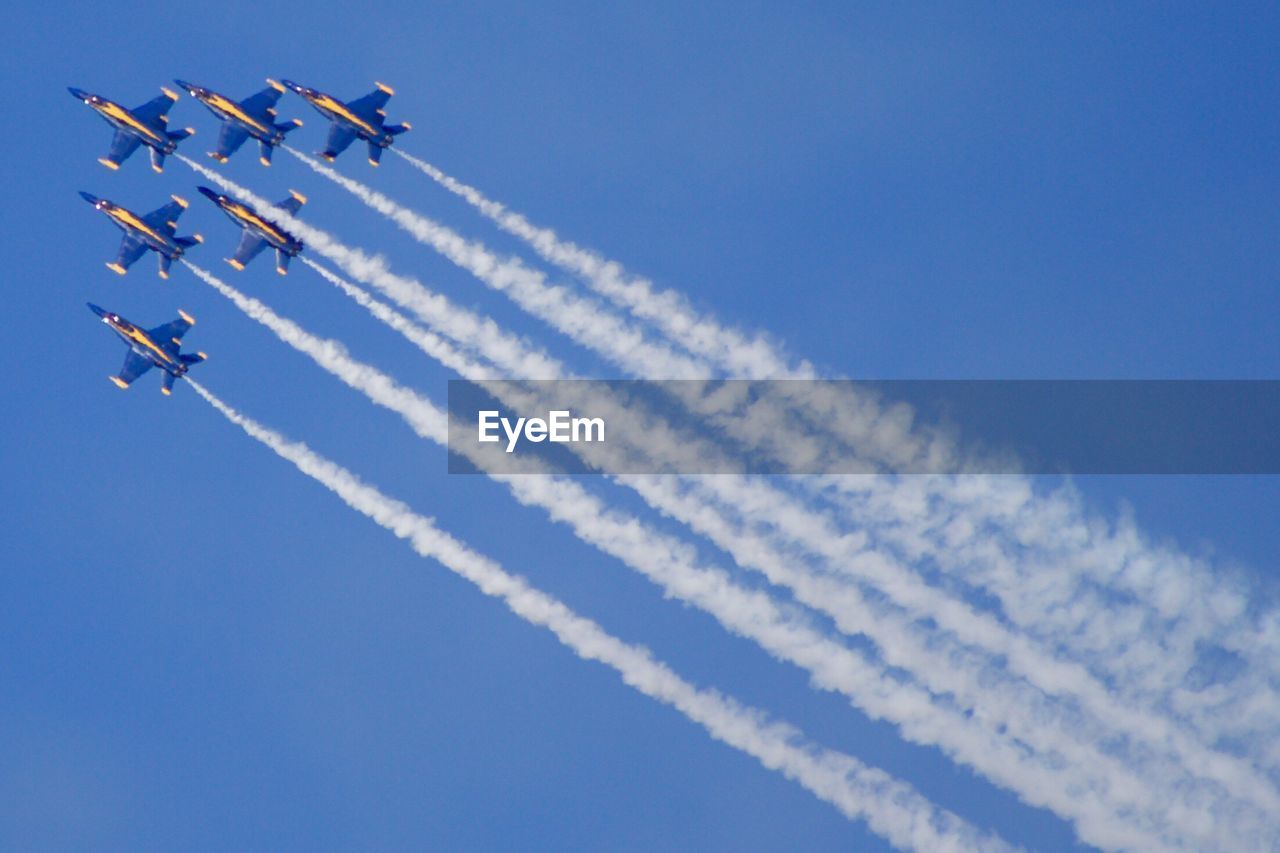 LOW ANGLE VIEW OF AIRSHOW AGAINST SKY