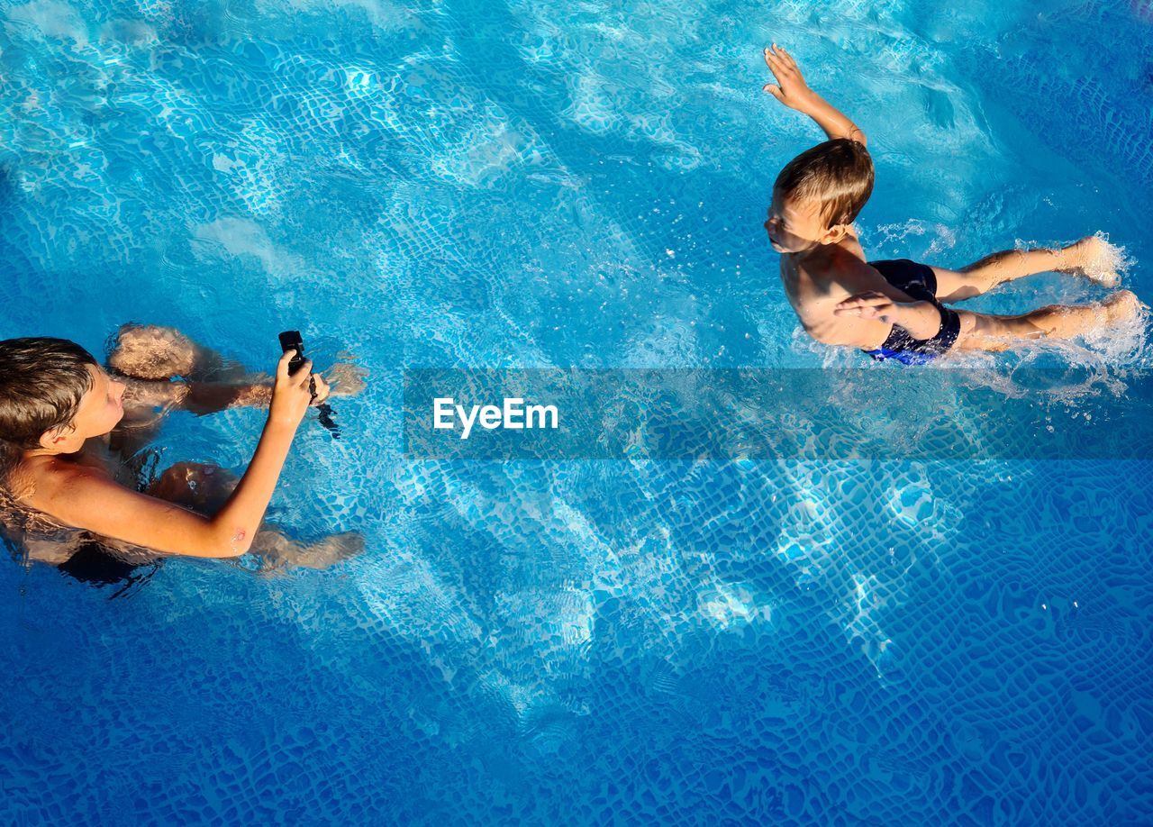 High angle view of people swimming in pool