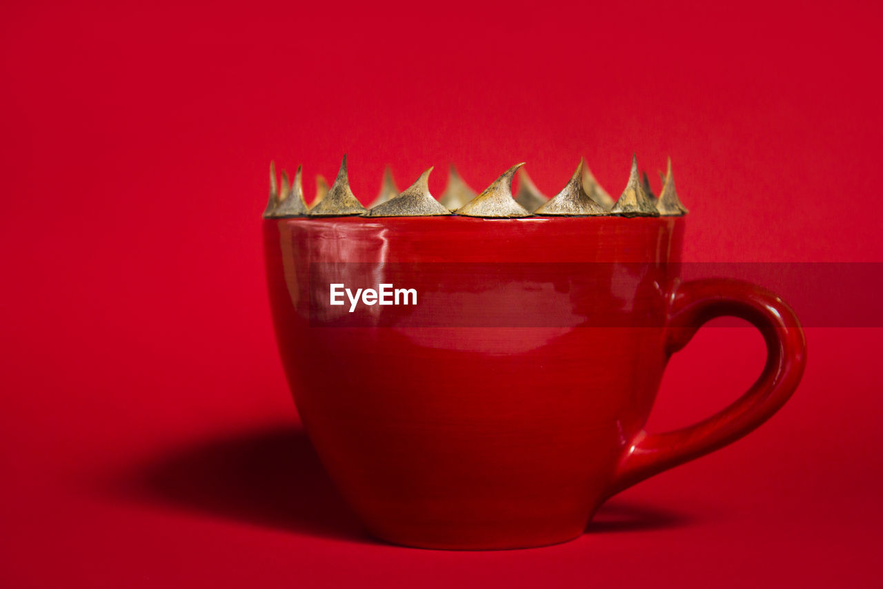 CLOSE-UP OF DRINK IN GLASS ON RED TABLE