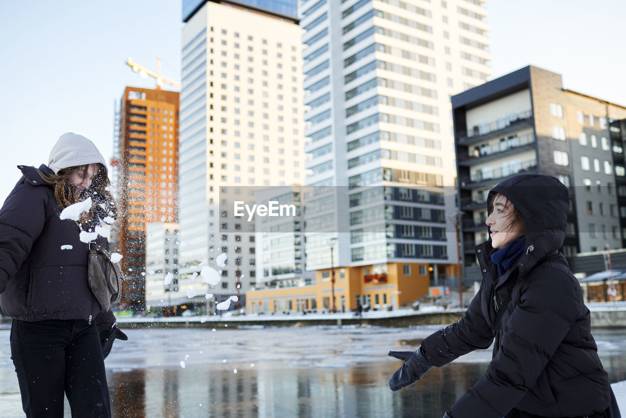 Young women having snowball fight