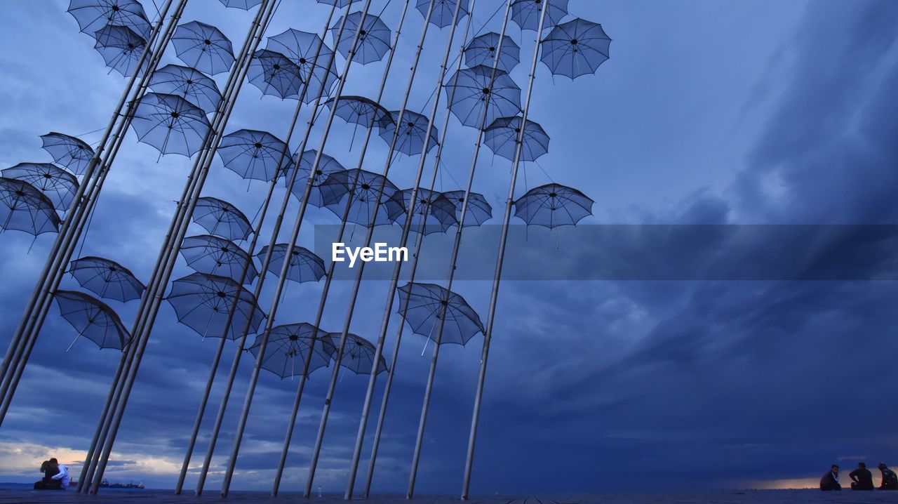 LOW ANGLE VIEW OF METAL STRUCTURE AGAINST CLOUDY SKY