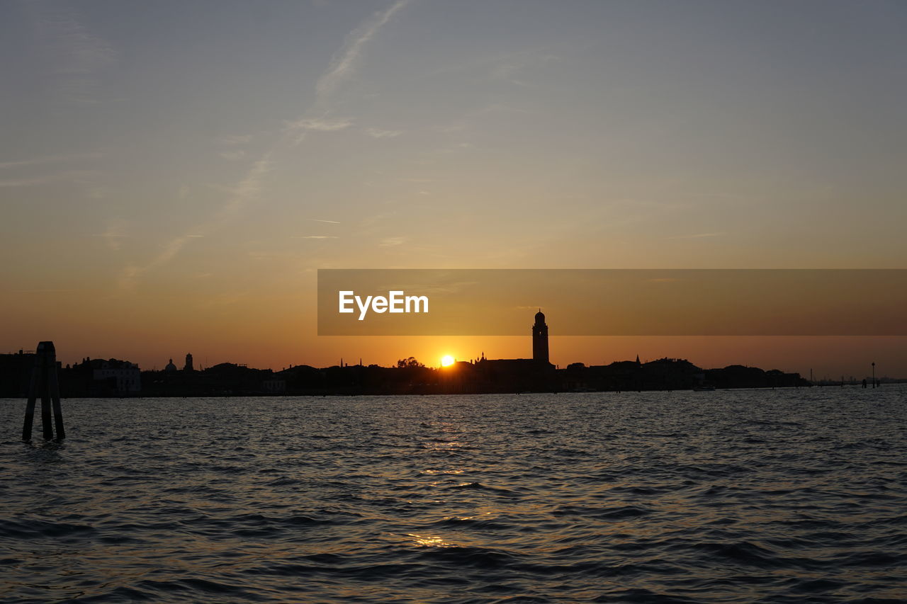 Silhouette from venice on sea against sky during sunset