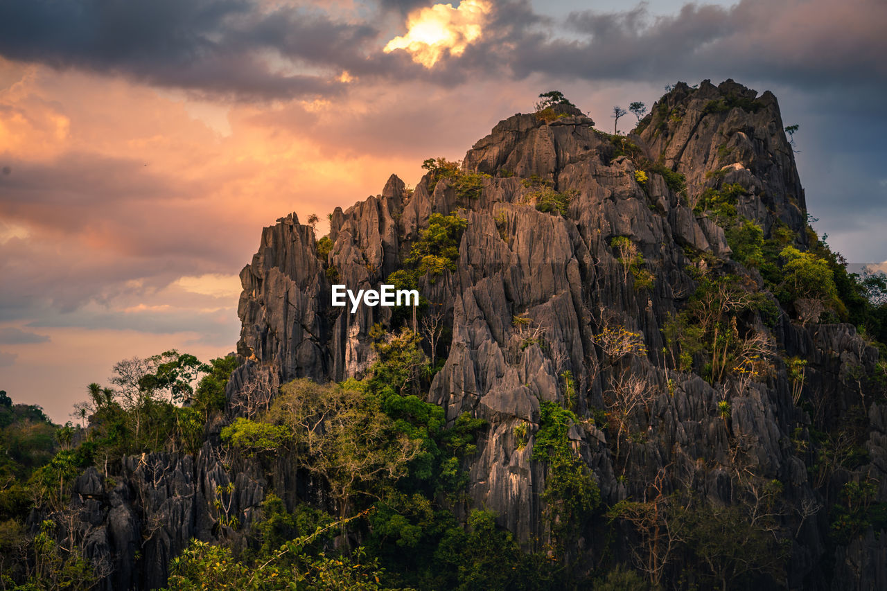 Low angle view of rock formation against sky during sunset