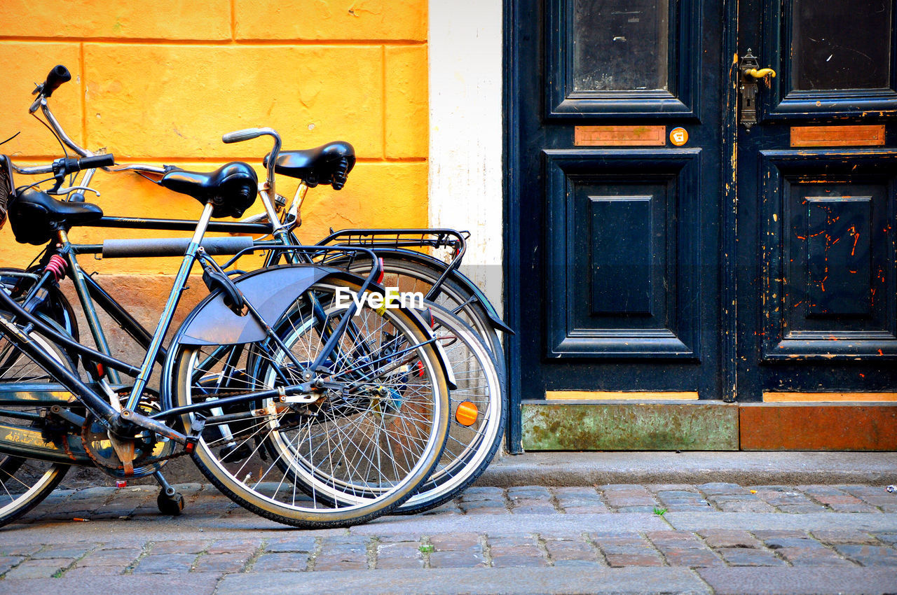 Bicycles on sidewalk against building