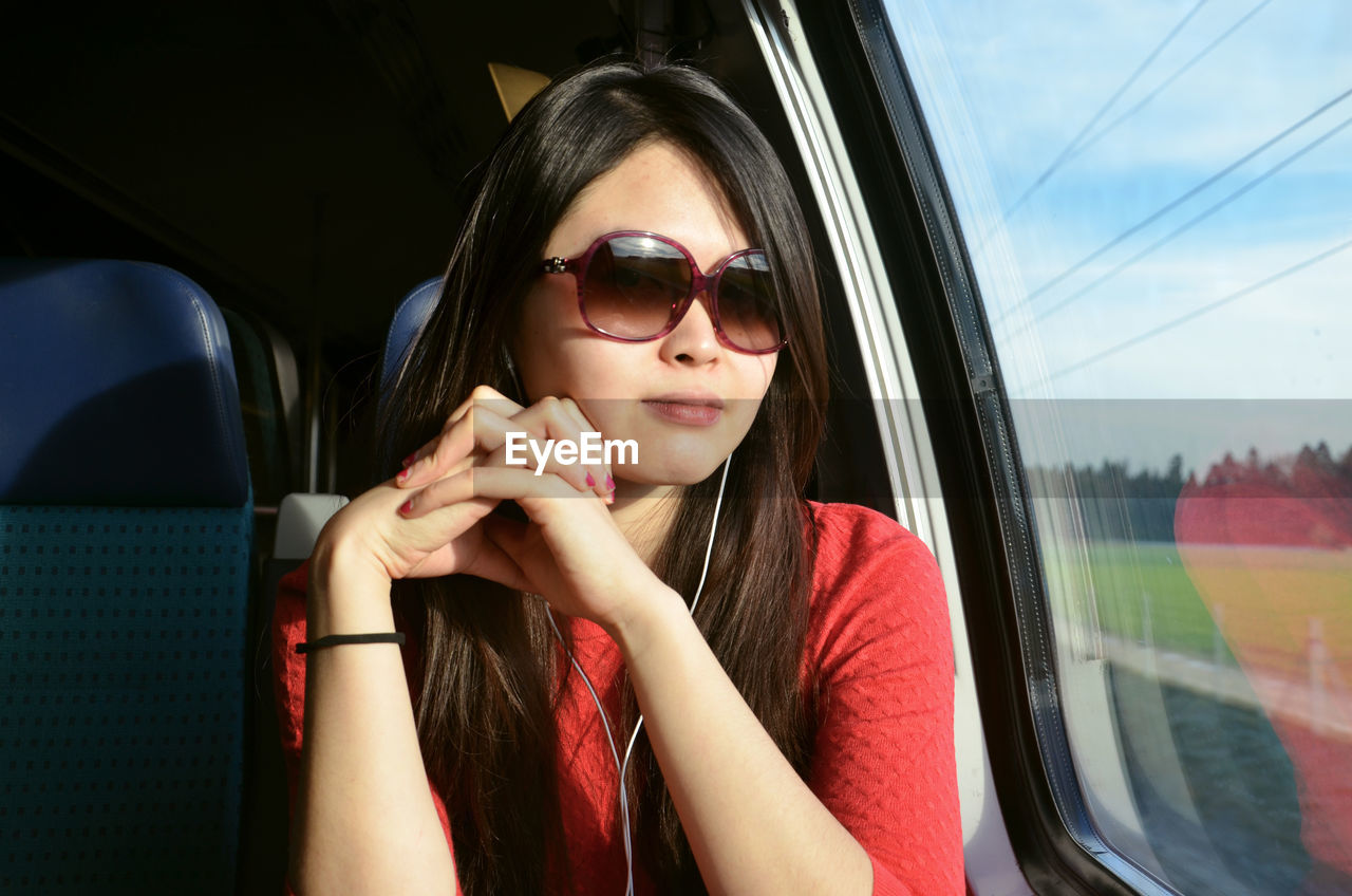 Portrait of young woman sitting in car