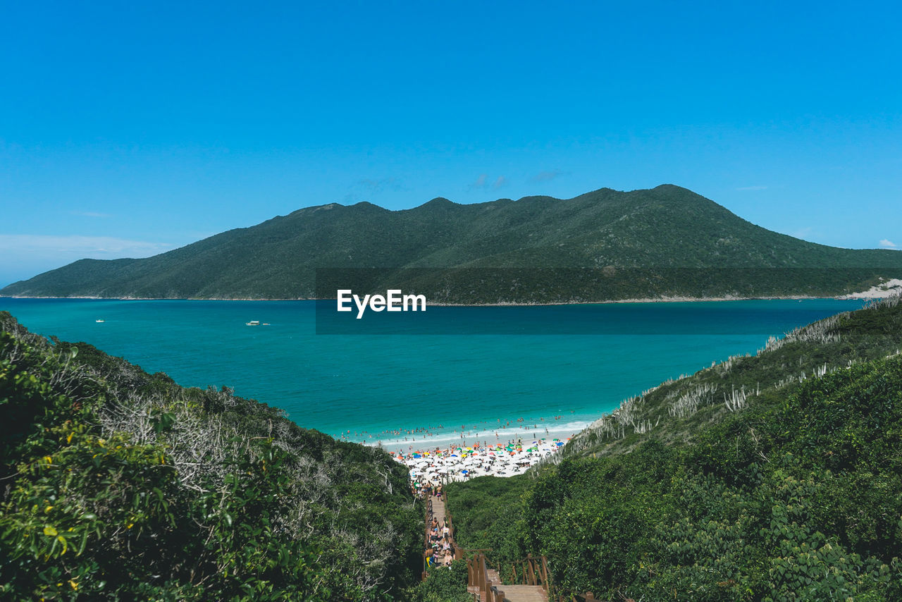 Scenic view of sea and mountains against sky