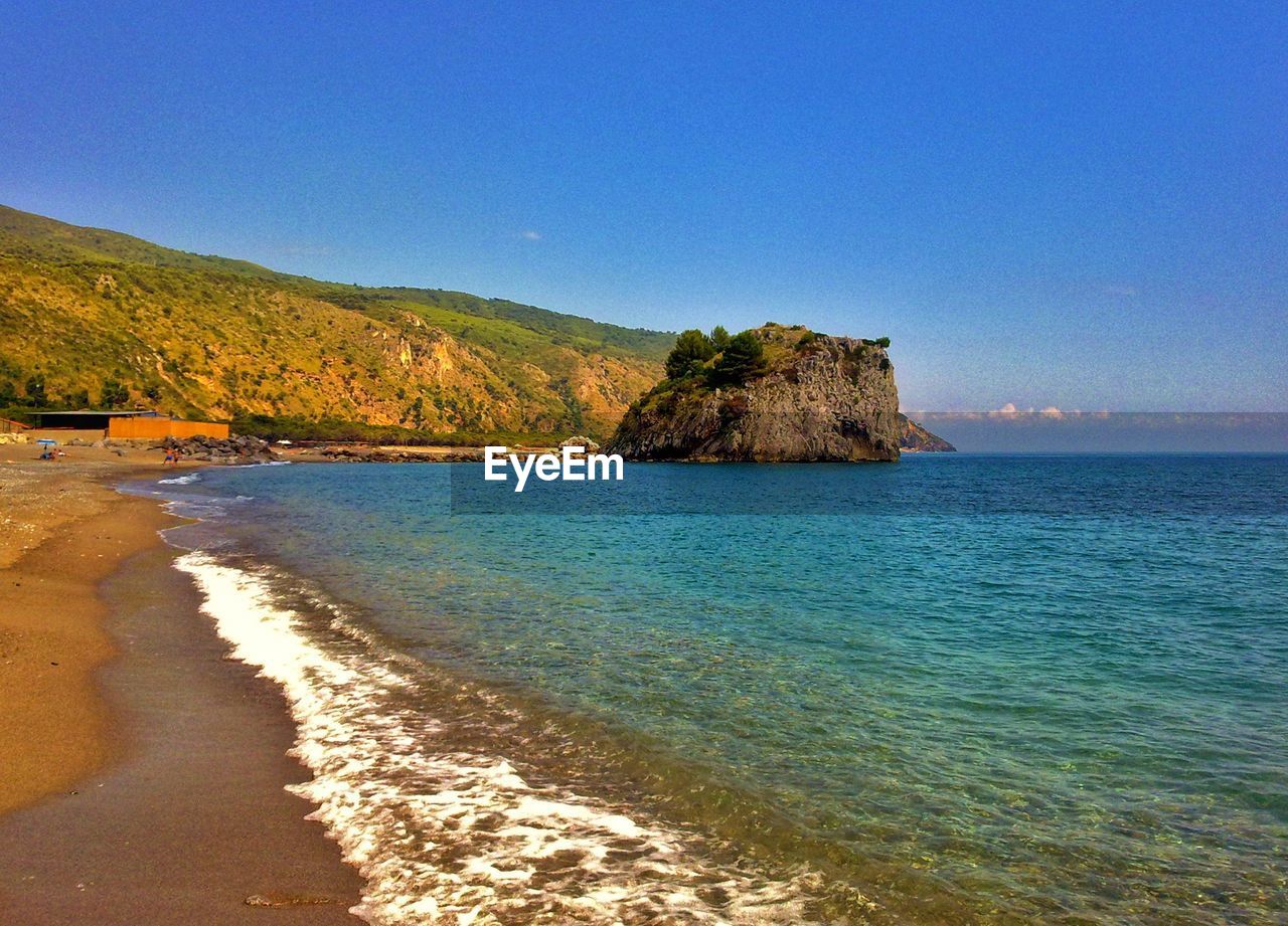 Scenic view of sea against clear blue sky