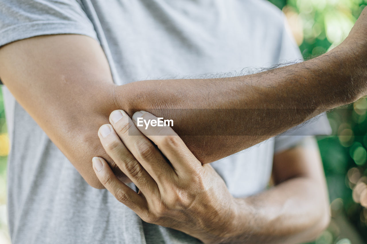 Close-up of man with elbow pain