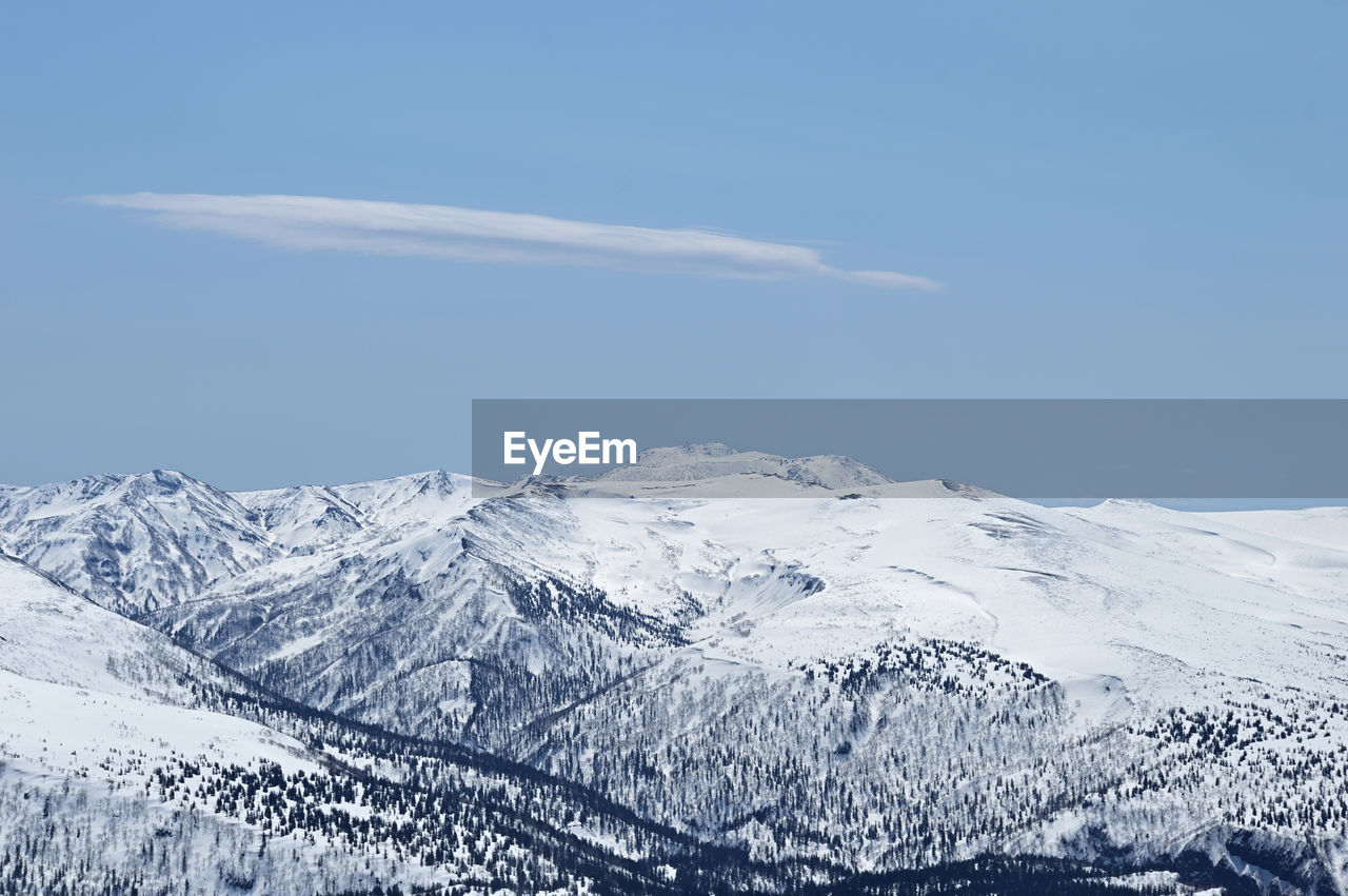 Scenic view of snow covered mountains against sky