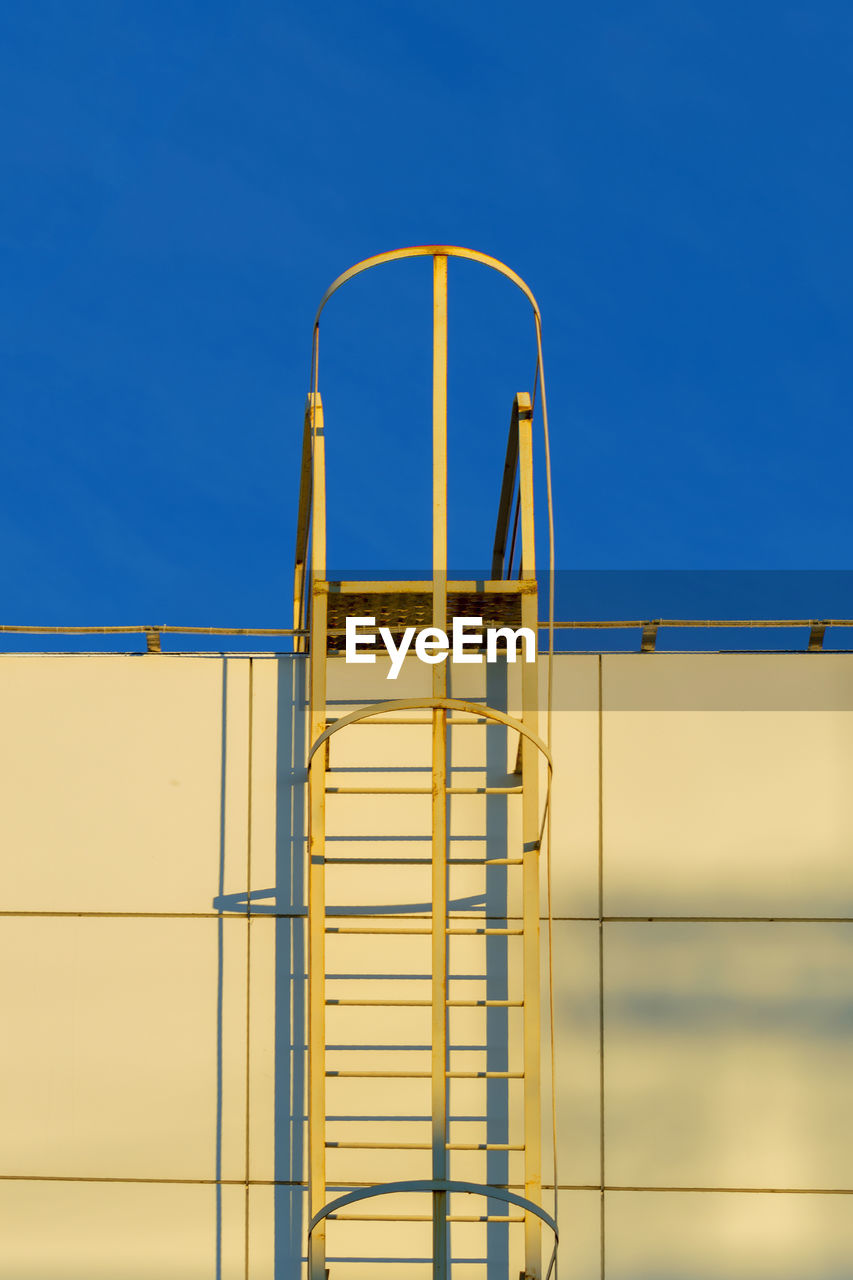 Low angle view of building against clear blue sky