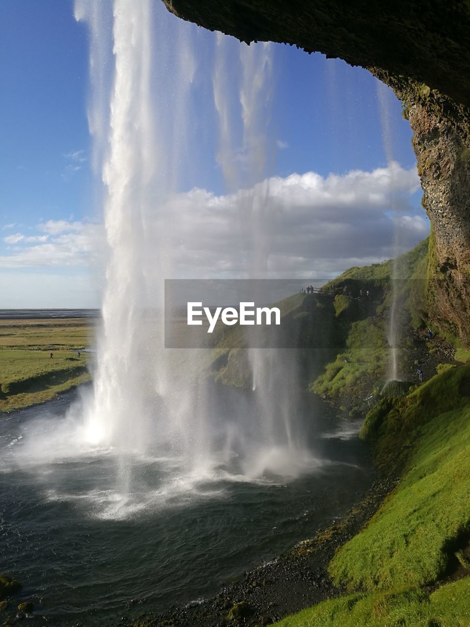 Scenic view of waterfall against sky