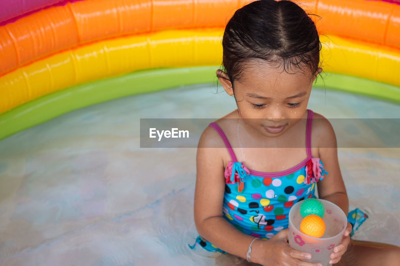 Girl playing in wading pool