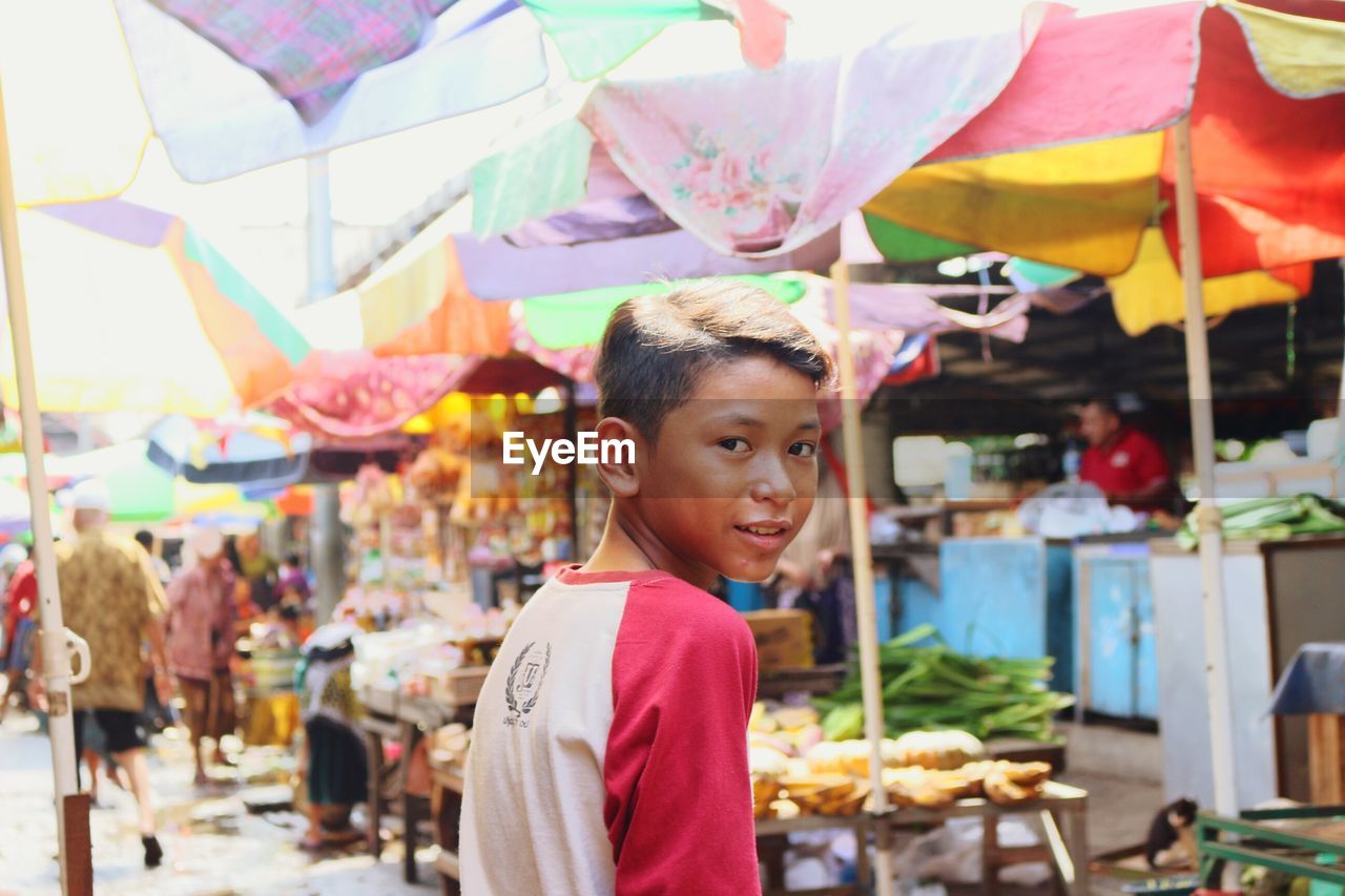 PORTRAIT OF HAPPY GIRL IN MARKET