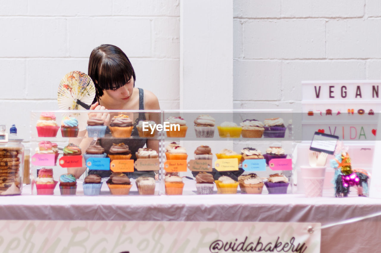 WOMAN LOOKING AT STORE FOR SALE