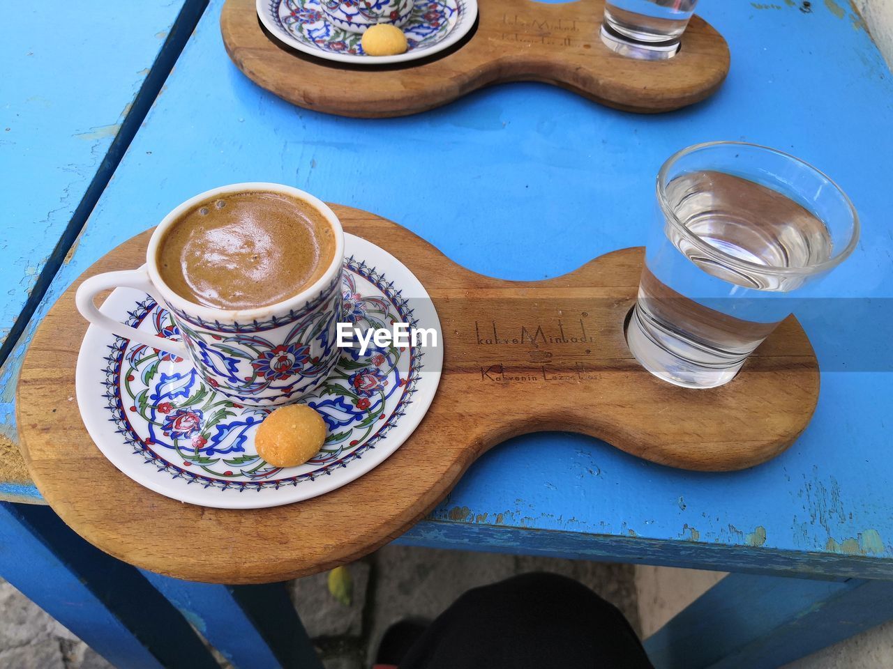 HIGH ANGLE VIEW OF COFFEE ON TABLE AGAINST BLUE SKY