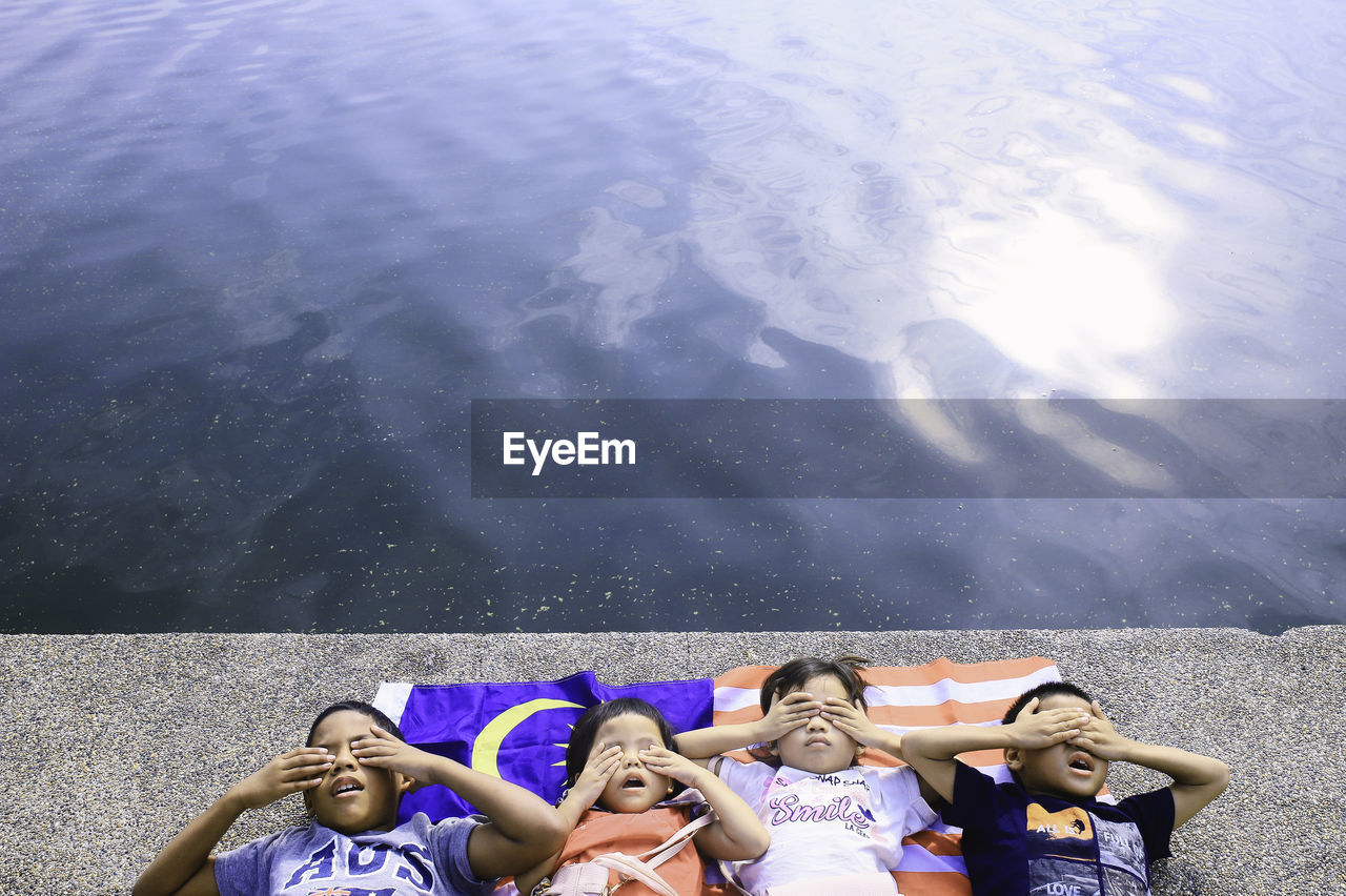 High angle view of children lying malaysian flag