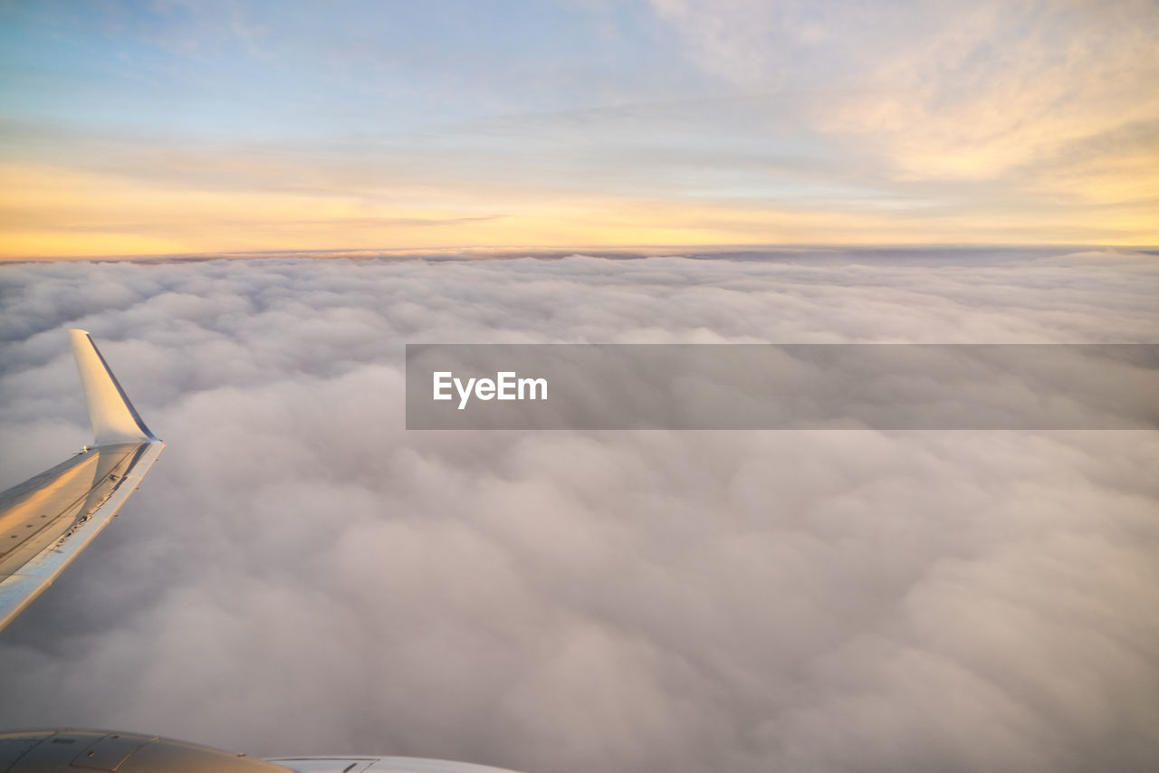 View from airplane by sunrise over the clouds in valencia