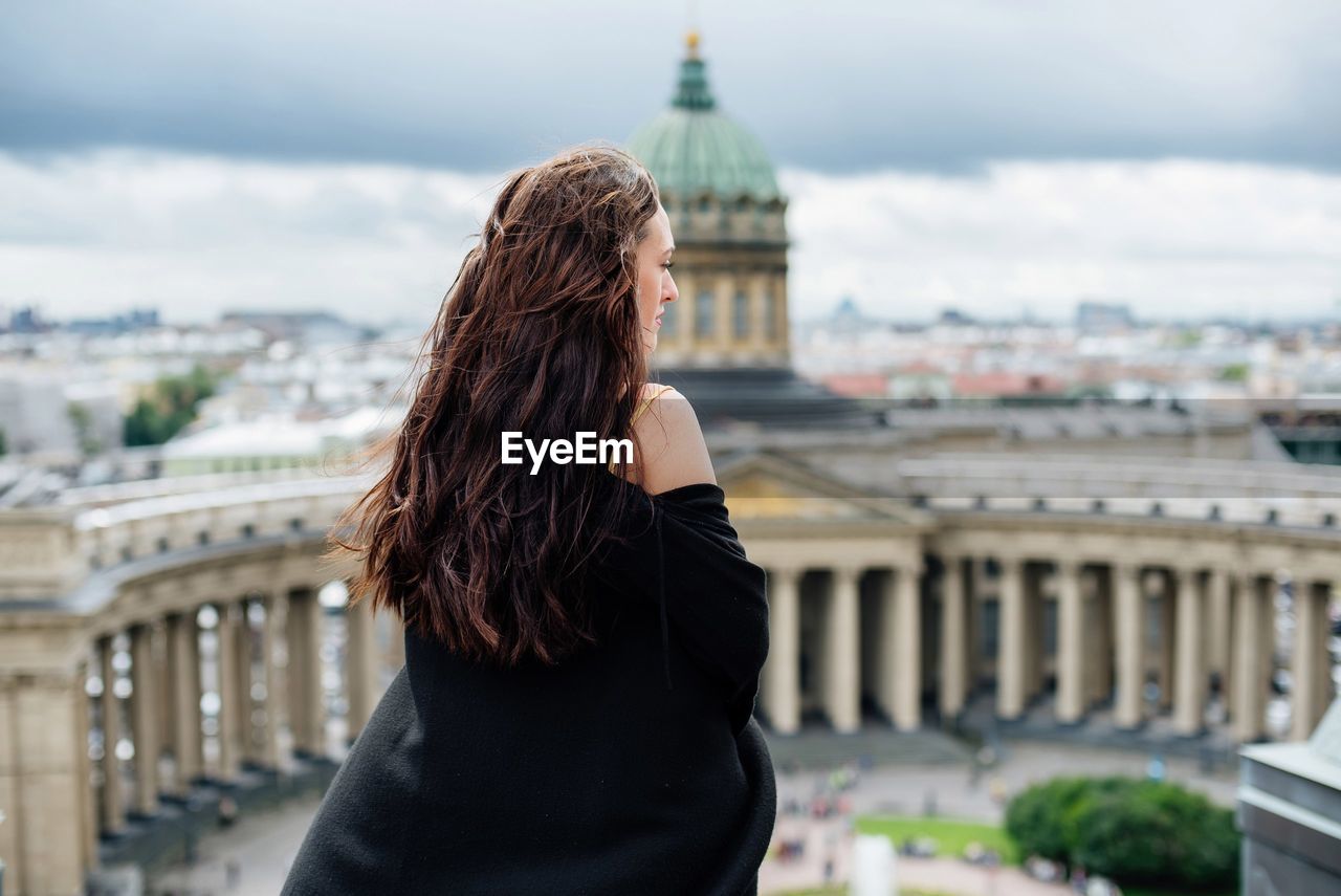 Rear view of woman standing in city