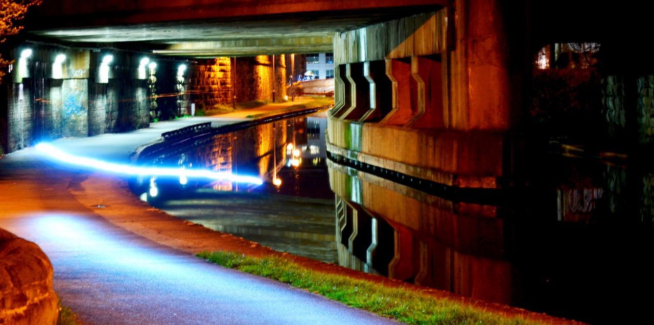 LIGHT TRAILS ON STREET AT NIGHT