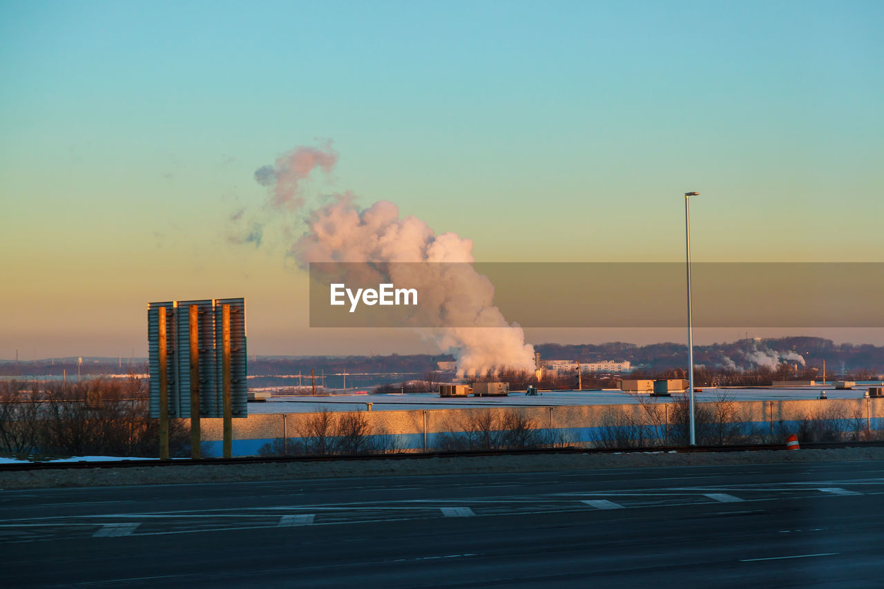 SMOKE EMITTING FROM FACTORY AGAINST CLEAR SKY