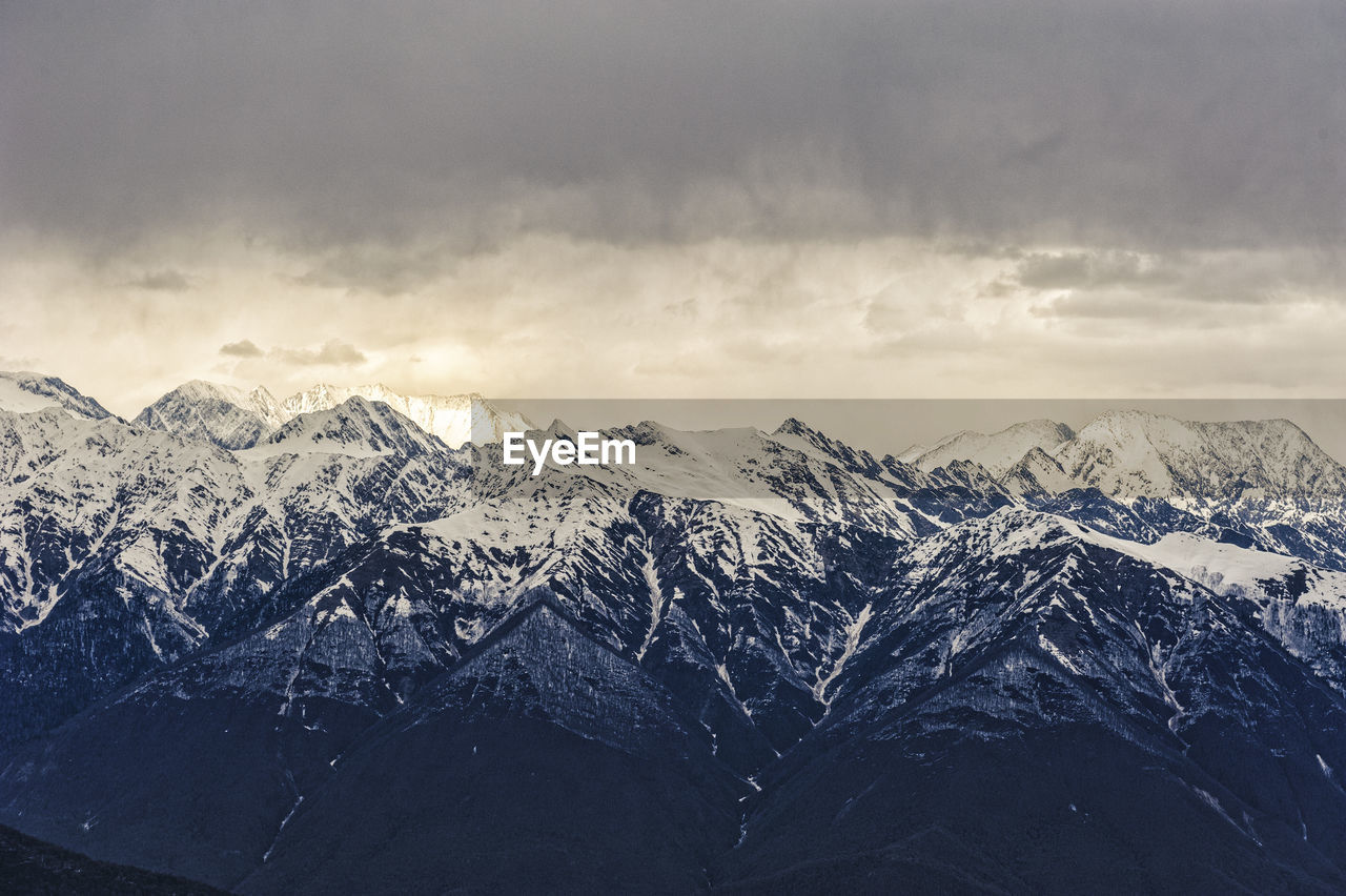 Scenic view of dramatic landscape against sky during winter