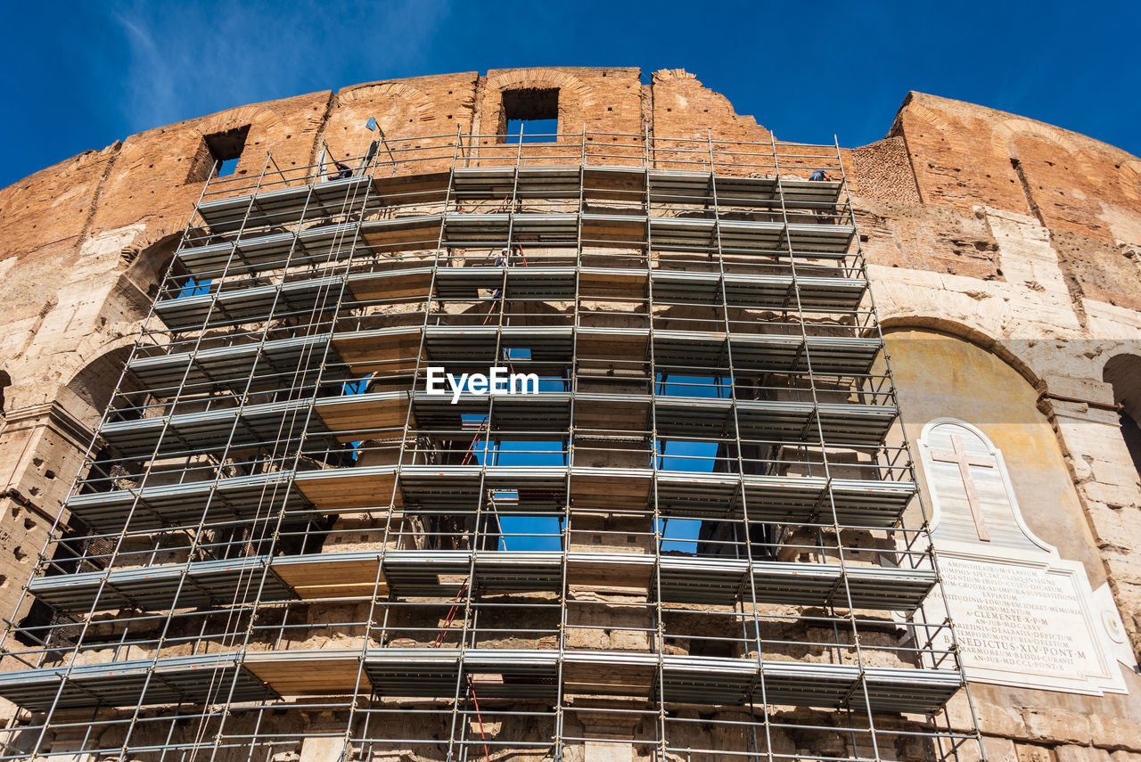 Construction scaffolding around the colosseum, the iconic symbol of imperial rome. italy