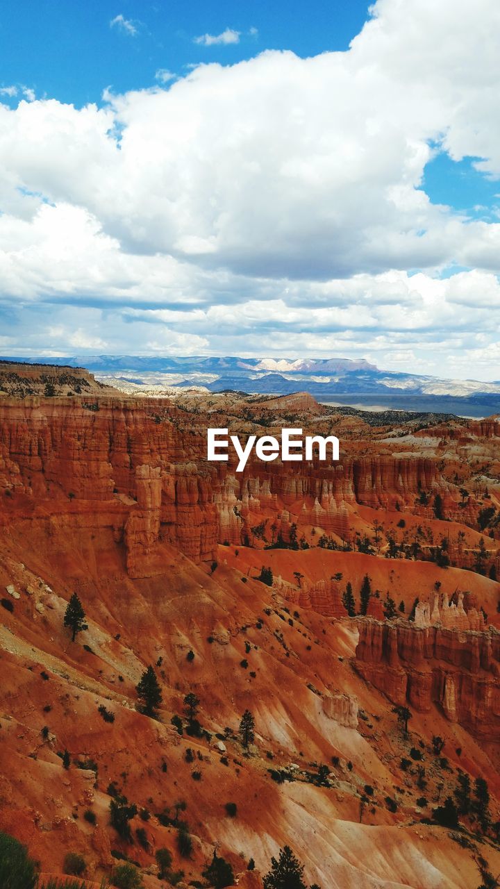 Scenic view of mountains against cloudy sky