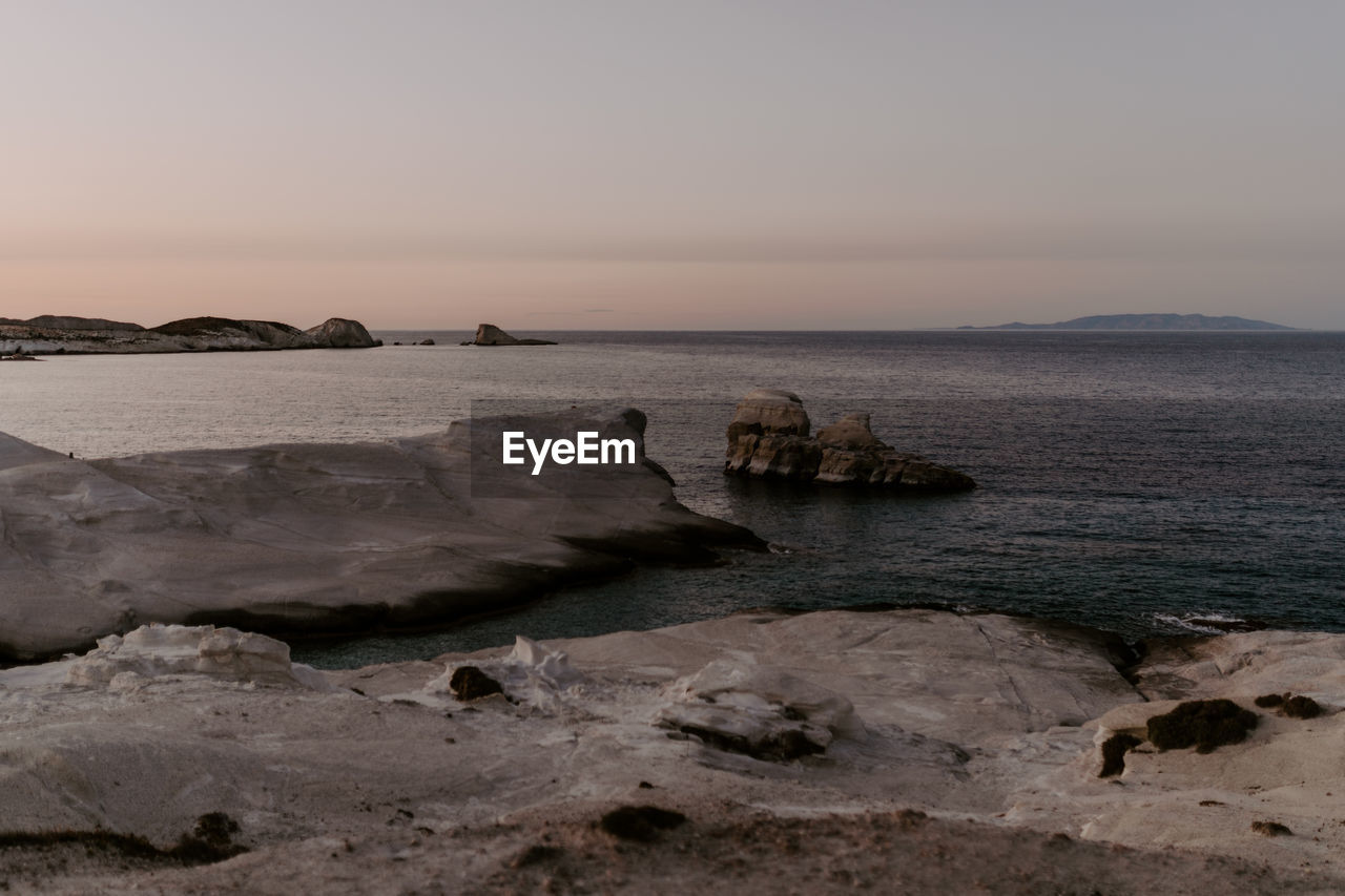 scenic view of beach against sky during sunset