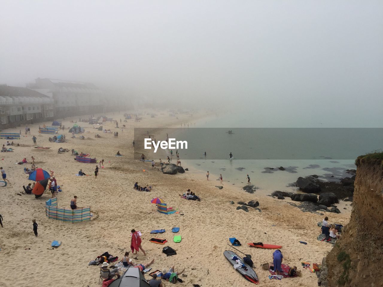 High angle view of people at beach in foggy weather