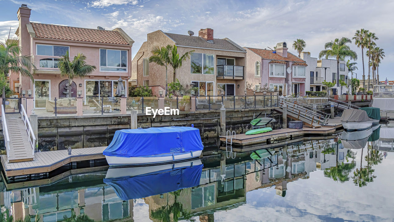 HOUSES BY SWIMMING POOL AGAINST BUILDINGS