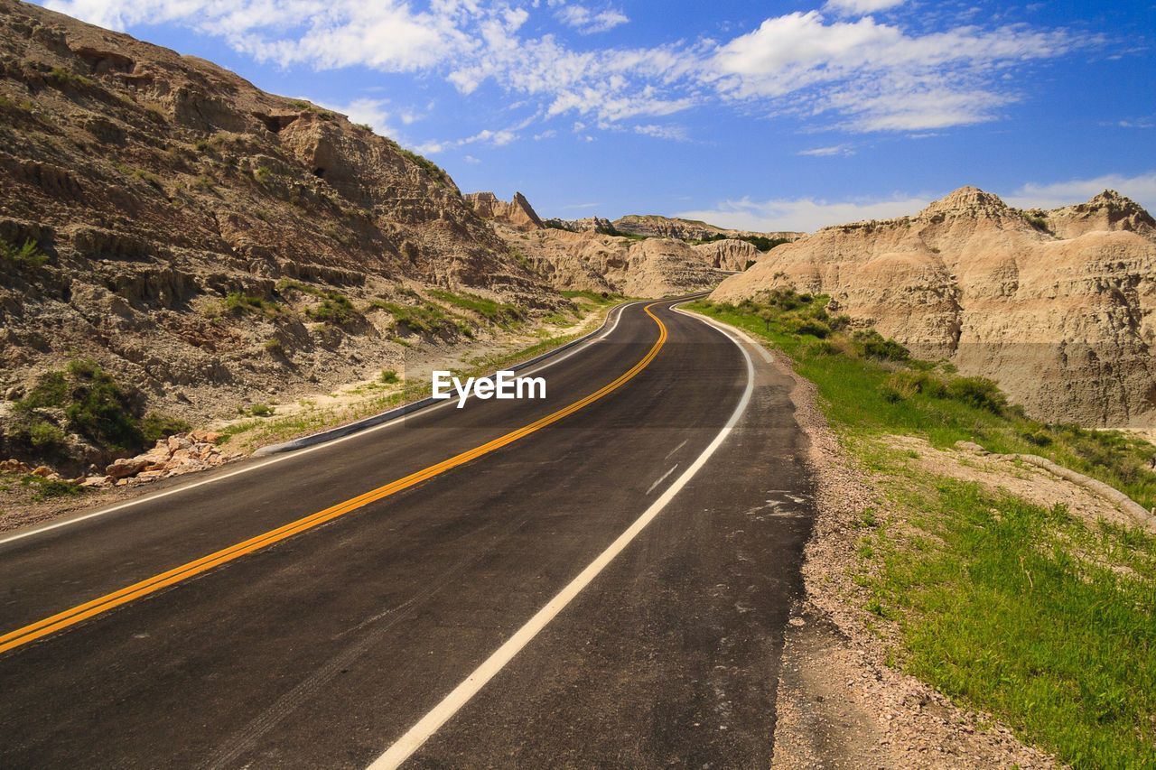 Empty road by mountain