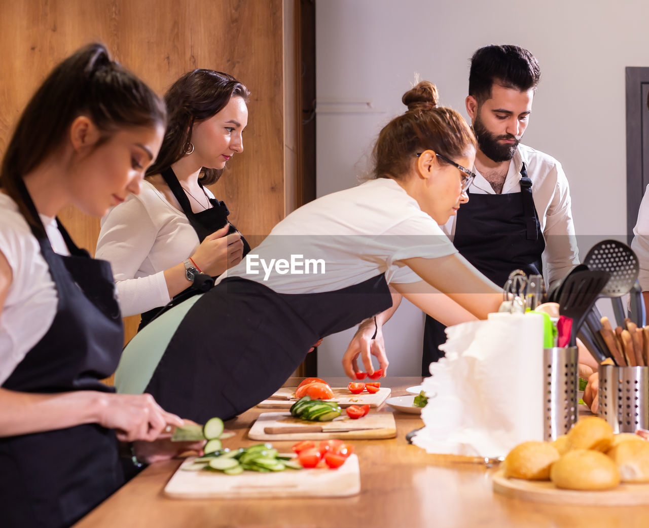 smiling friends working at table at home