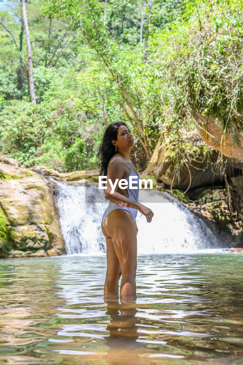 Full length of woman standing in water