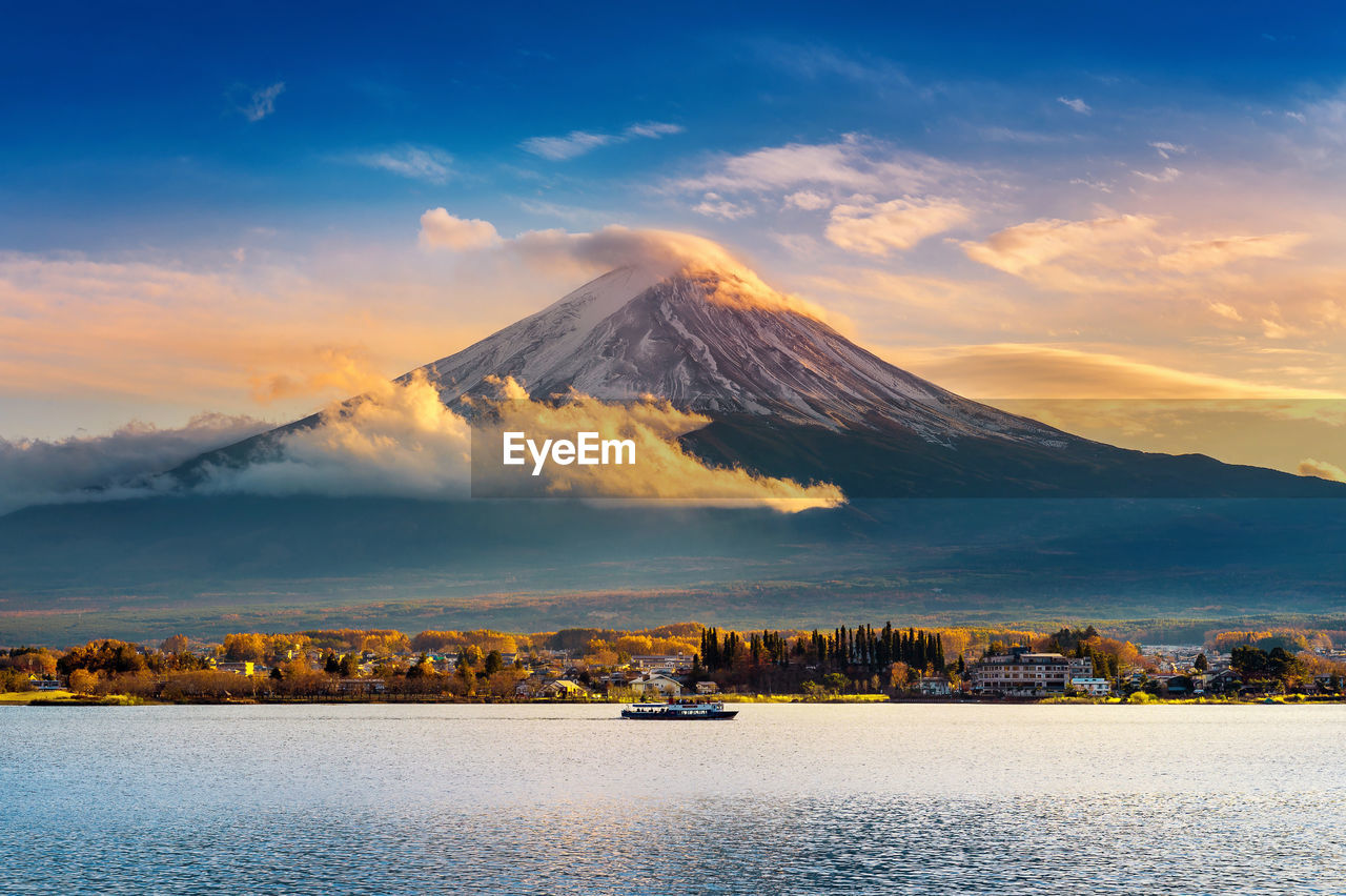 Scenic view of lake and mount fuji against sky during sunset