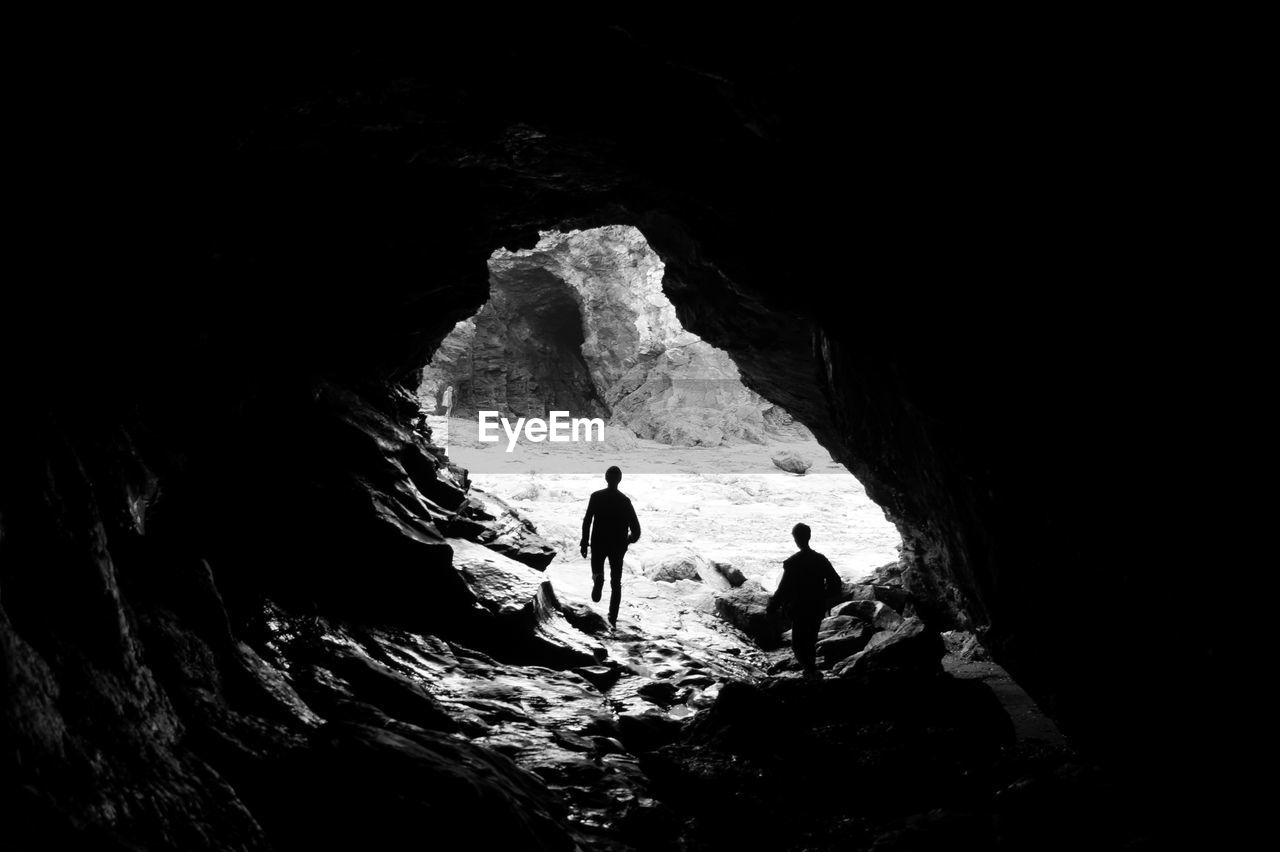 Silhouette of friends in cave