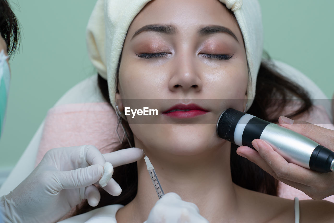 Close-up of woman receiving plastic surgery on face