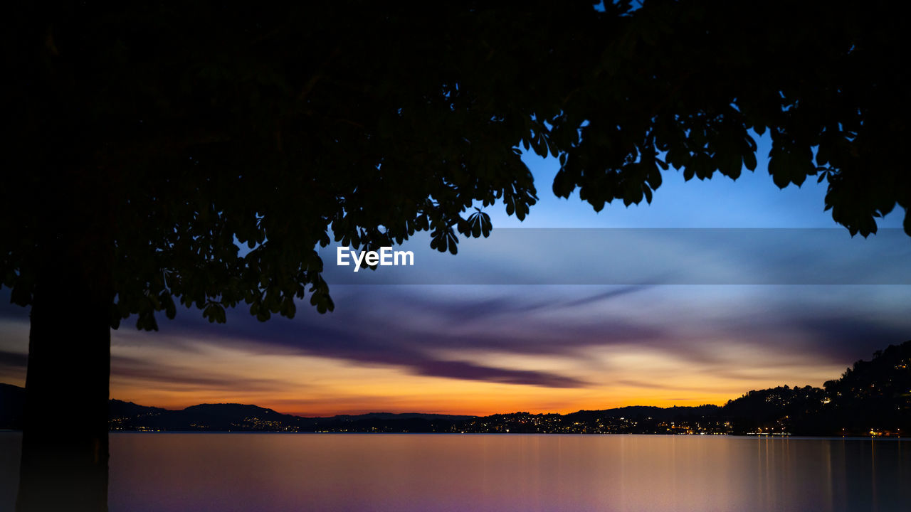 Scenic view of lake against sky during sunset