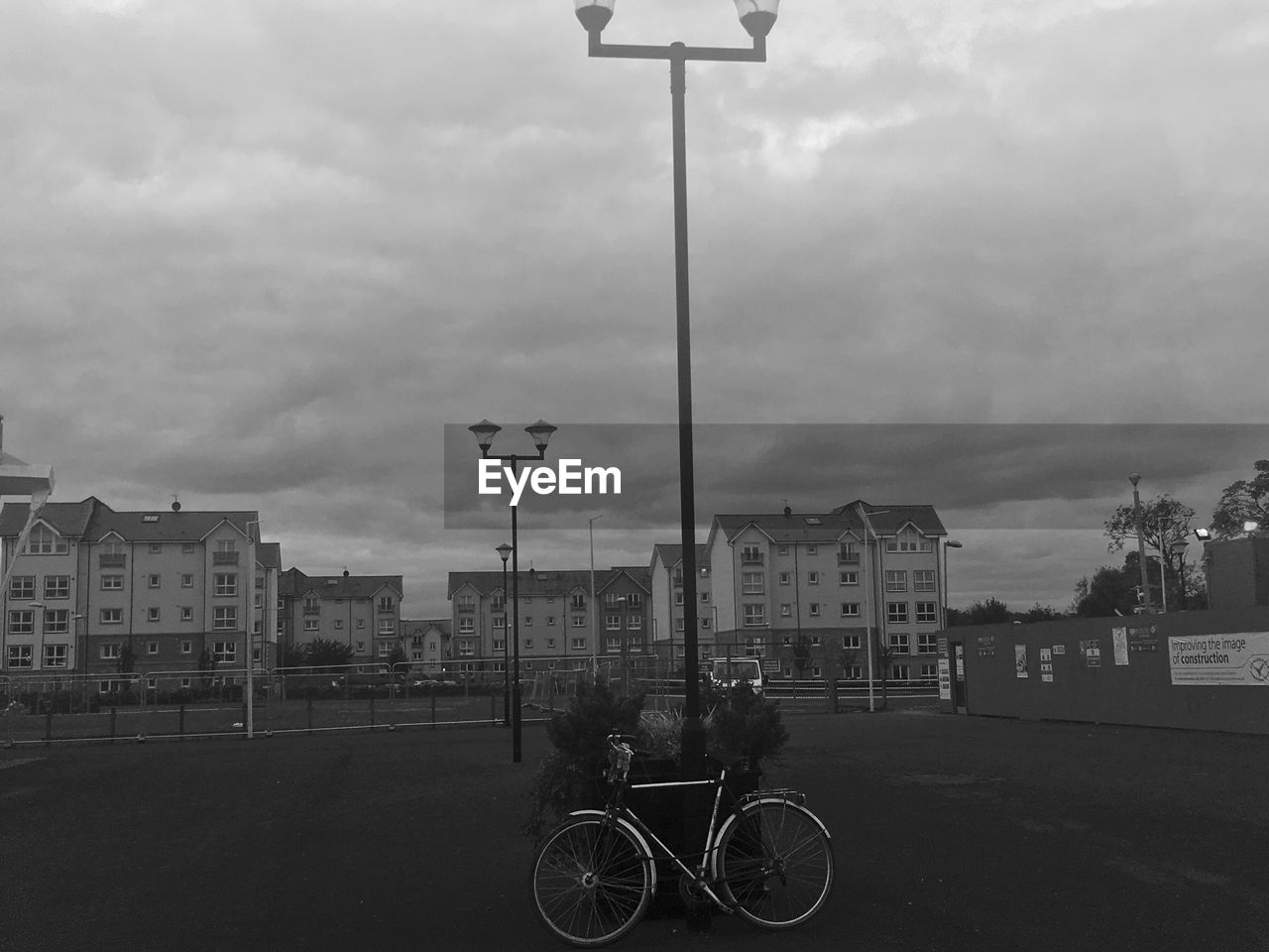 BICYCLE PARKED AGAINST CLOUDY SKY